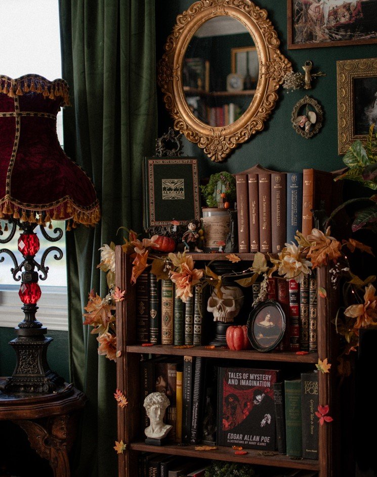 Gothic Bookshelf With a Skull, Gilded Mirror, and Fall Garland